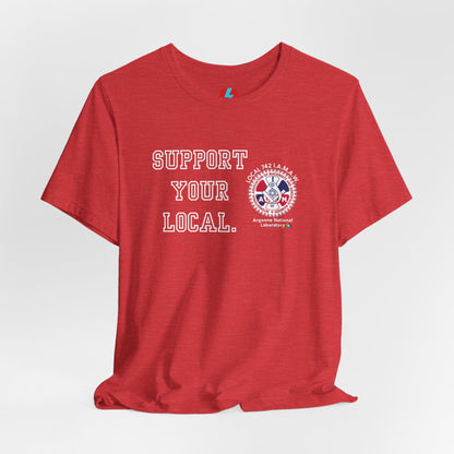 A blue unisex jersey short sleeve tee from Printify showcases the text "SUPPORT YOUR LOCAL" in bold white capital letters on the front. Additionally, it features a white and red graphic emblem for the Atomic Trades & Labor Council, AFL-CIO, Local 148 with "Argonne National Laboratory" text beneath it. Wear this Support Your Local - IAMAW 742 shirt to show your union solidarity.