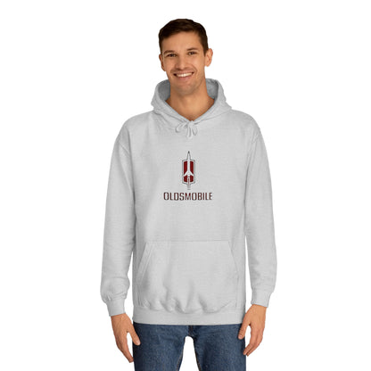 The Oldsmobile 1970s Logo - Unisex College Hoodie by Printify offers a cozy fit in white, featuring a red and black Oldsmobile logo on the front with a stylized rocket above "OLDSMOBILE." It includes a kangaroo pocket and drawstring hood for classic comfort.