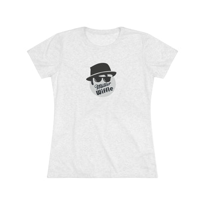 A cozy red t-shirt, the Miller Wiffel Ball - Blues Brothers - Women's Triblend Tee by Printify, features a graphic of a masked face wearing a fedora hat and sunglasses, along with the text "Miller Wiffle." The t-shirt is displayed on a wooden floor, paired with a denim jacket, white sneakers, and a potted green plant to create a vintage look.