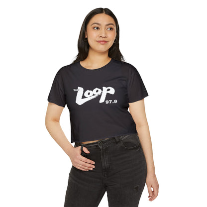 Printify's Women's Festival Crop Top features a grey design with short sleeves and a round neckline. The crop top displays the text "The Loop 97.9" in white, with the word "Loop" styled in a brushstroke-like font—ideal for fans of Chicago’s iconic rock radio station who appreciate retro fashion.