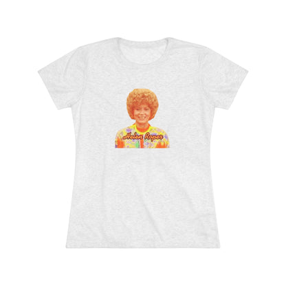 A Women's Triblend Tee by Printify, titled "Helen Roper - Three's Company," features a red design with an illustration of a smiling person with curly hair and colorful clothing. Below the illustration, the text "Helen Roper" is written in a bold, retro font, capturing the essence of vintage TV humor.