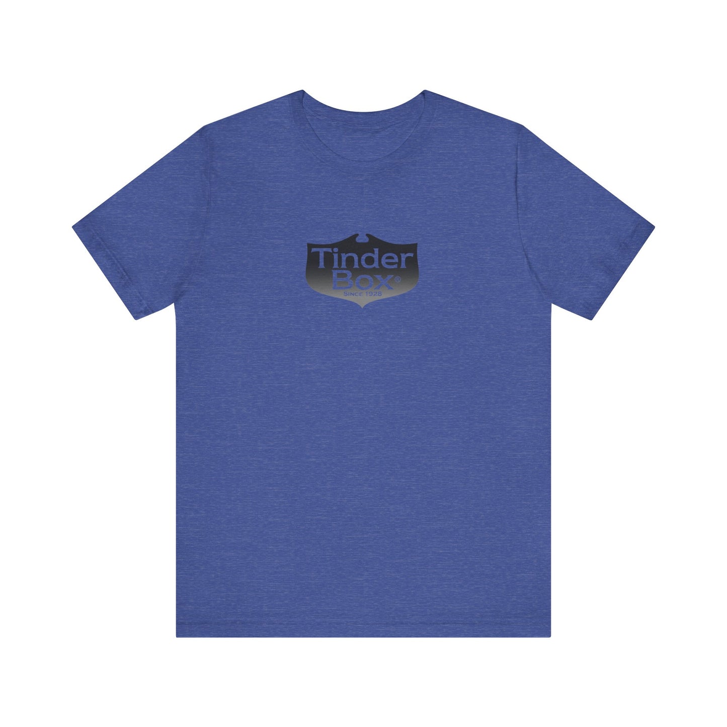 A light blue Printify "The Tinder Box 1980s" unisex jersey short sleeve tee featuring the "Tinder Box" logo in the center. The logo consists of a dark shield with the words "Tinder Box" in white text, with a small flame icon replacing the dot above the "i".