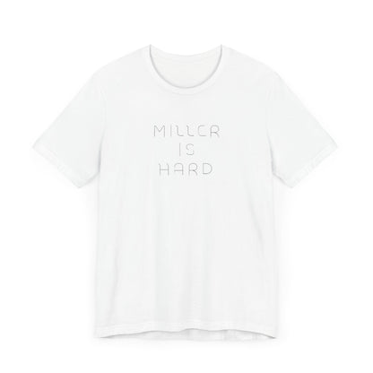 The Miller is Hard - White Letters - Unisex Jersey Short Sleeve Tee by Printify features a rust-colored design with "MILLER IS HARD" printed in bold, white capitals on the front. Below, "GARY, IN." is added in smaller font. This simple yet striking shirt evokes the spirit of Miller Beach with no additional graphics or patterns.