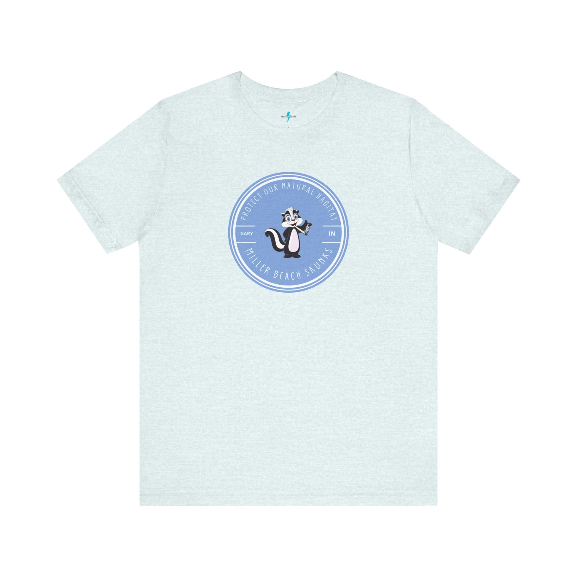 The Printify Miller Beach Skunks - Unisex Jersey Short Sleeve Tee is a gray T-shirt that features a circular blue logo at the center. Inside the logo, there is an illustration of a skunk with the text "Protect Our Habitat" and "Miller Beach Skunks" around the border, promoting environmental consciousness. The upper left part of the logo reads "Gary, IN.