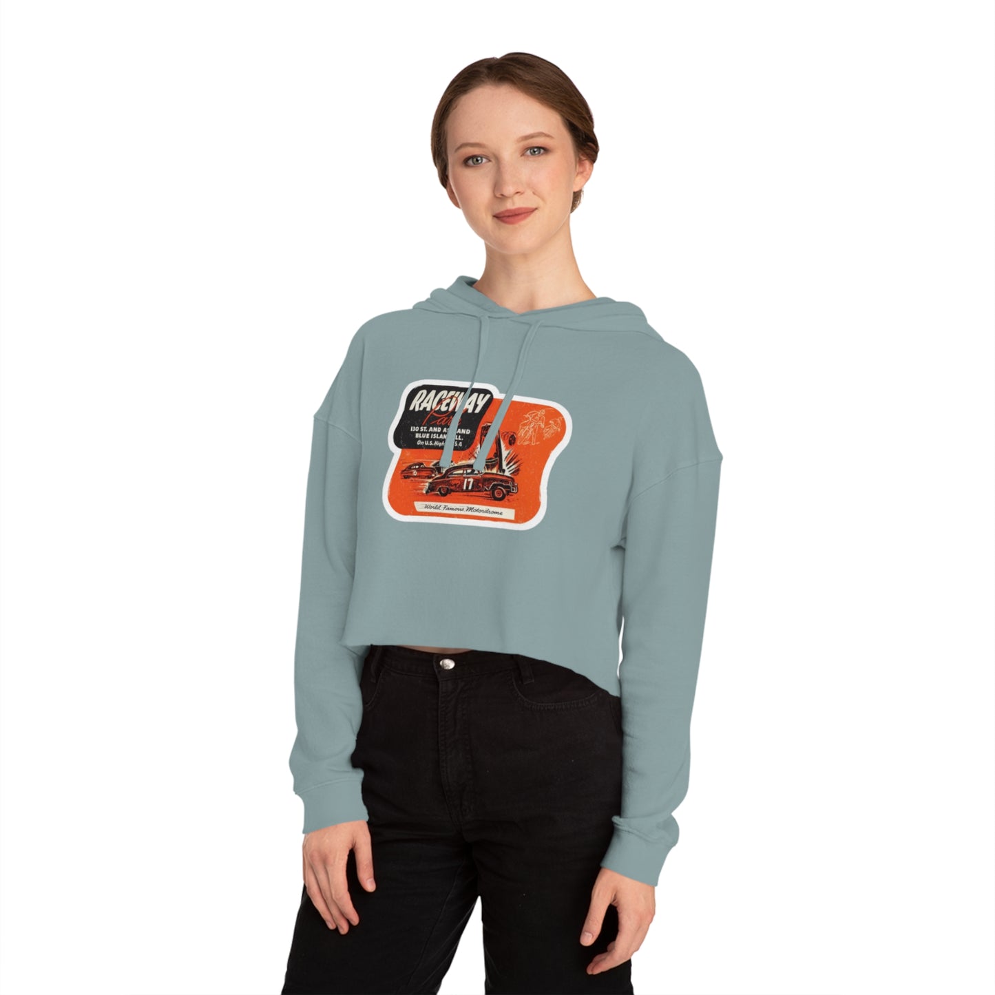 The Raceway Park - Blue Island, IL Women's Cropped Hooded Sweatshirt by Printify features an eye-catching camouflage pattern with a bold red and black "Raceway Park" graphic. Perfect for car enthusiasts, it is adorned with images of cars and text that celebrate a fictional race and hot rod theme, capturing the spirit of Blue Island racers.