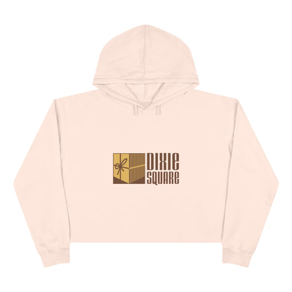 Pink cropped hoodie from Printify, showcasing a yellow and brown "Dixie Square" logo with a ribbon design on the front, reminiscent of the iconic Dixie Square Mall in Harvey, IL from the Blues Brothers era.