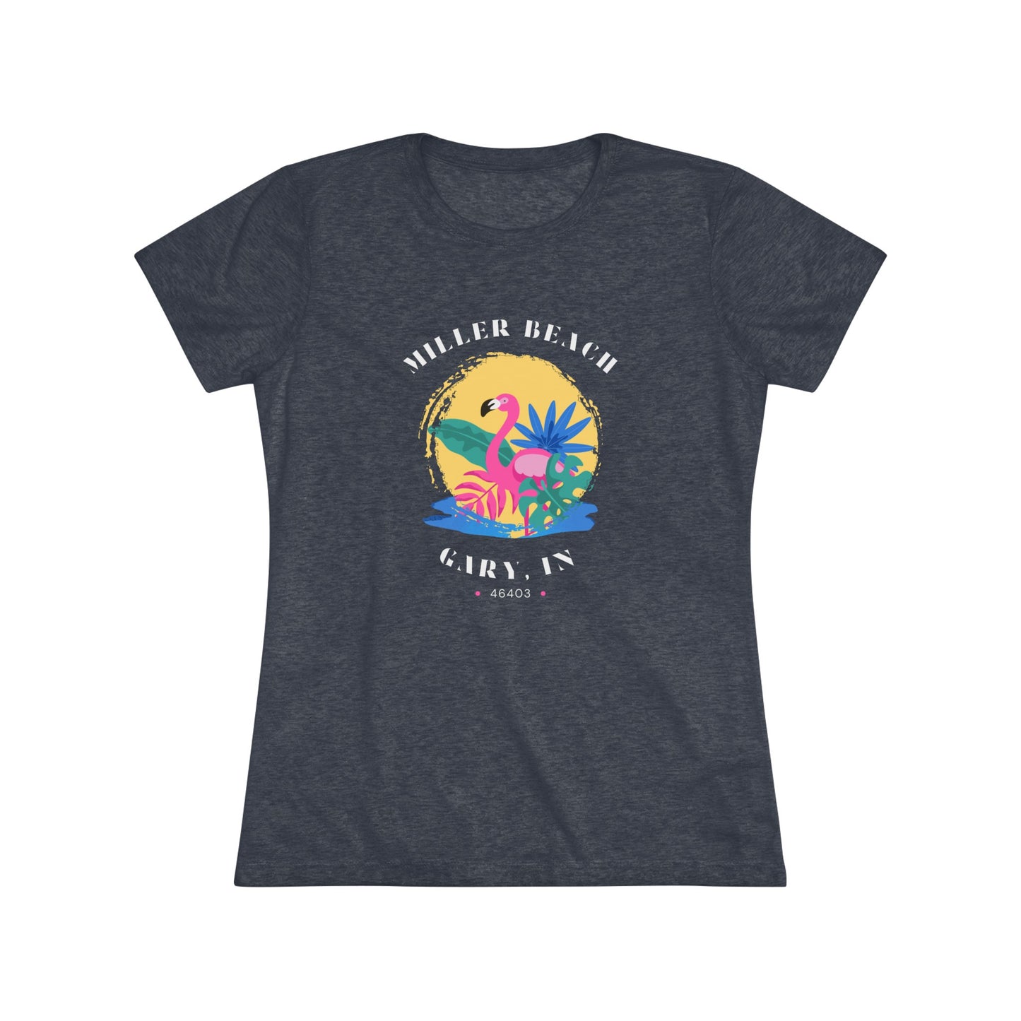 A women's triblend tee from Printify, the Miller Beach Flamingo features a blue color and "Miller Beach Gary, IN 46403" text with a vibrant design of a flamingo amidst tropical foliage for a vintage aesthetic. This t-shirt is showcased on a wooden surface alongside a denim jacket, white sneakers, and a potted plant.