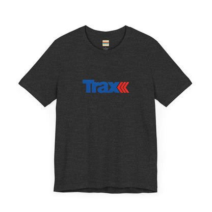 A gray unisex jersey short sleeve tee from Printify, inspired by retro 1980s Kmart style. The "Trax" logo is printed in blue letters, followed by three red arrows pointing to the right. This classic Trax Brand T-shirt is laid flat against a white background, capturing nostalgic fashion vibes.