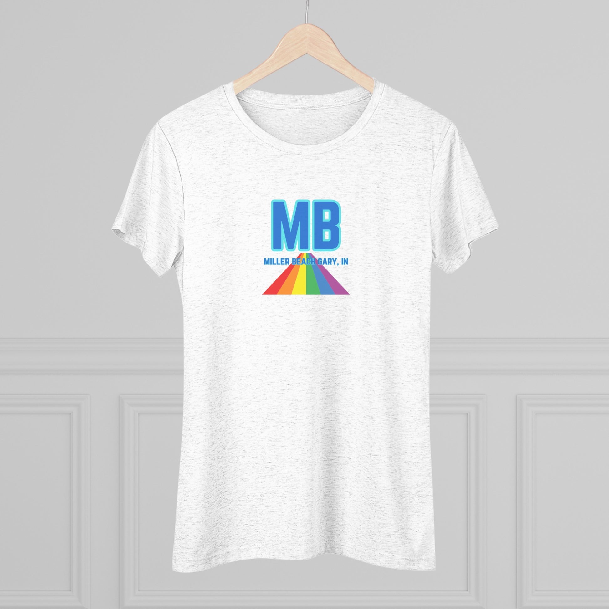 The Miller Beach Pride - Women's Triblend Tee by Printify is a dark gray, cozy t-shirt with a vintage look, featuring the text "MB" in large blue letters at the center. Below the letters, there is a rainbow-colored triangular design with "Millions & Binary, Inc." written in smaller text under the rainbow triangle.