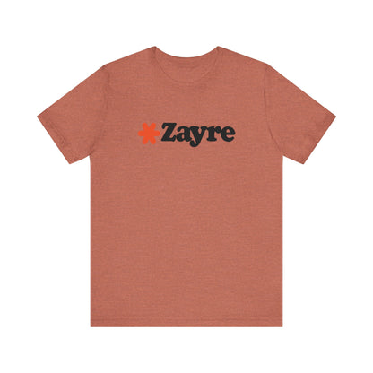 The Zayre Stores Logo - Retro 1980s Unisex Jersey Short Sleeve Tee by Printify features a gray design with the word "Zayre" printed in black letters and a red asterisk preceding the text. Reminiscent of retro fashion from the Zayre 1980s Retail Store, this shirt is displayed against a minimalistic white background and appears to be made of soft, comfortable fabric.