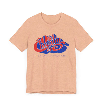 The "Old Chicago Mall Bolingbrook 1980s Retro - Unisex Jersey Short Sleeve Tee" from Printify is a gray T-shirt showcasing a vintage design with the text "Old Chicago" in blue and red. Beneath the main text, the address "355 S. Bolingbrook Drive, Bolingbrook, Illinois" appears in smaller font, evoking 80s nostalgia of the Old Chicago Mall. The shirt is displayed against a white background.