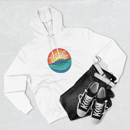 The Miller Beach Abstract - Three-Panel Fleece Hoodie by Printify is a premium light gray pullover featuring a vibrant circular front design. It showcases an abstract sunset-over-ocean scene with blue waters, an orange to red gradient sky, and a city skyline silhouette. Made from soft combed ring-spun cotton and lined with cozy fleece for extra warmth.