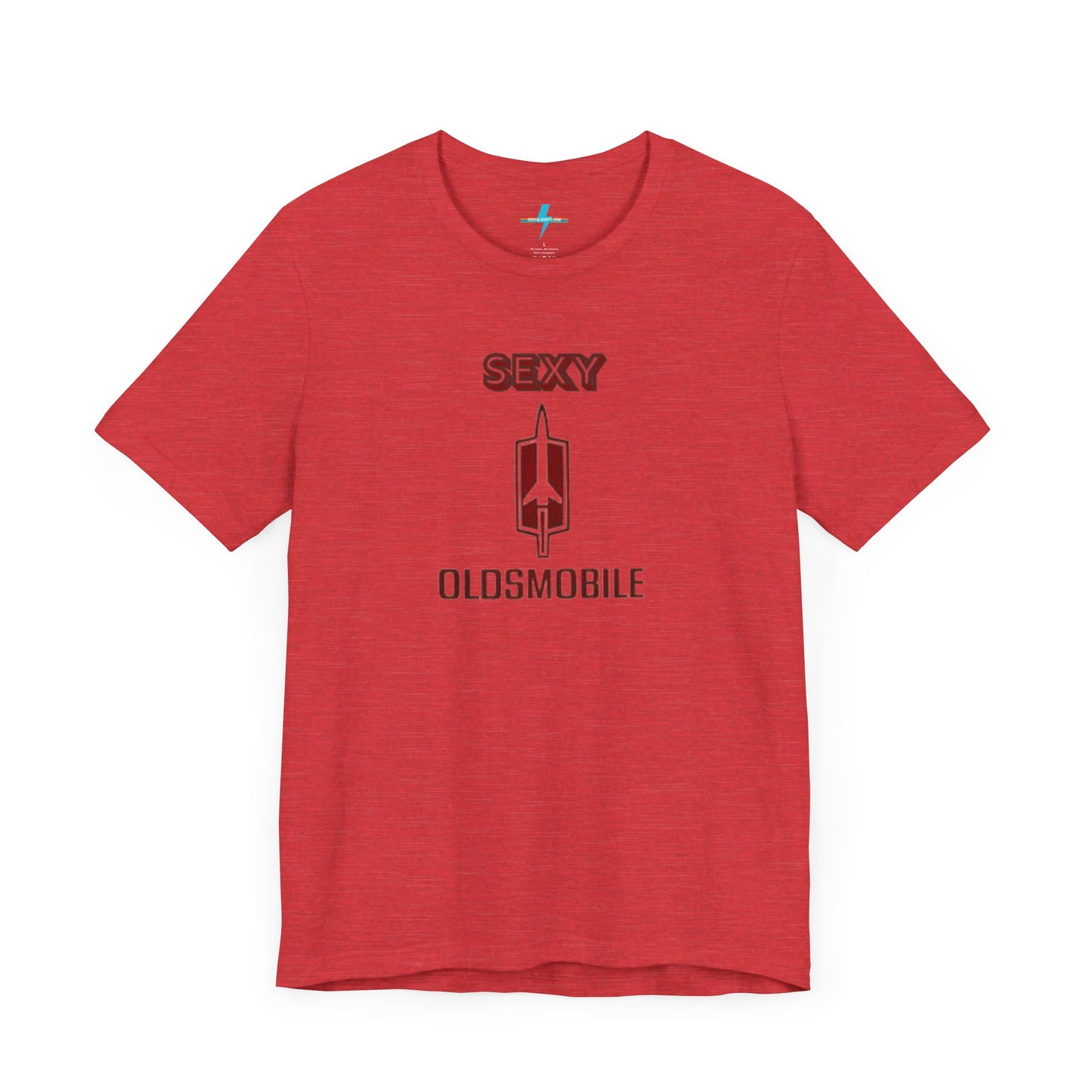 Introducing the Sexy Oldsmobile - Unisex Jersey Short Sleeve Tee by Printify, a light gray t-shirt featuring a striking graphic in the center. The design includes the word "SEXY" in bold red letters above a vertical Oldsmobile logo, underlined by the word "OLDSMOBILE" in red letters. This t-shirt is perfect for vintage car enthusiasts and comedy lovers alike, with its plain white background accentuating the bold design.