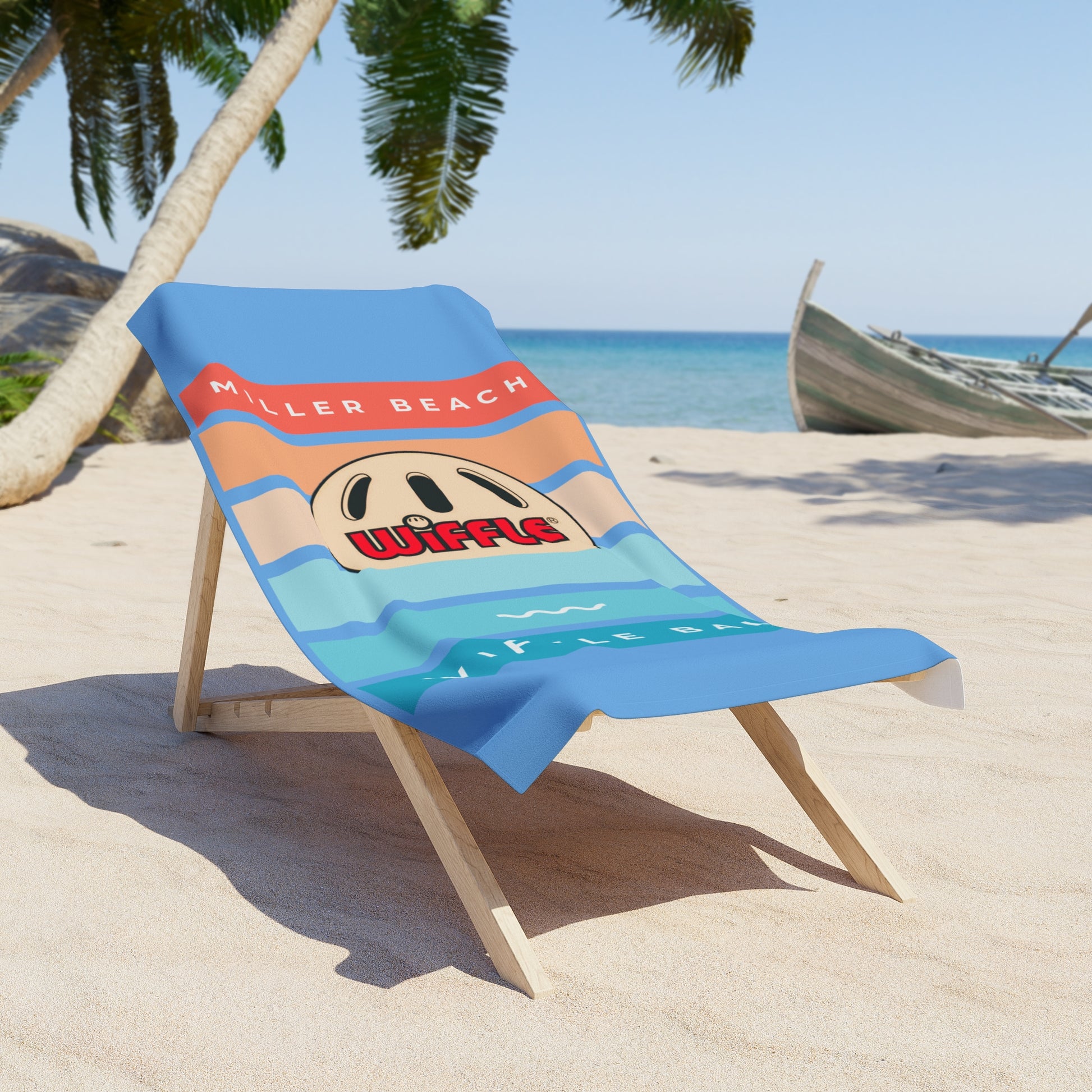 A wooden lounge chair with a luxurious Printify Miller Beach Wiffel Ball - Sunset Beach Towel draped over it sits on a sandy beach. The towel features a design with the words "KILLER BEACH," a cartoon wiffel, and waves. Palm trees, a boat, and a clear blue sea are visible in the background under a bright sky.