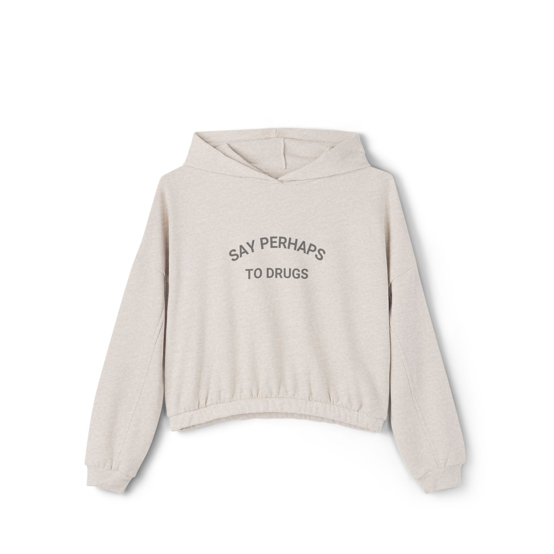 A person confidently stands in front of the camera with one hand on their hip, wearing a Printify "Say Perhaps to Drugs" Women's Cinched Bottom Hoodie. Crafted from soft Airlume cotton, this light-colored cropped hoodie pairs stylishly with blue jeans.