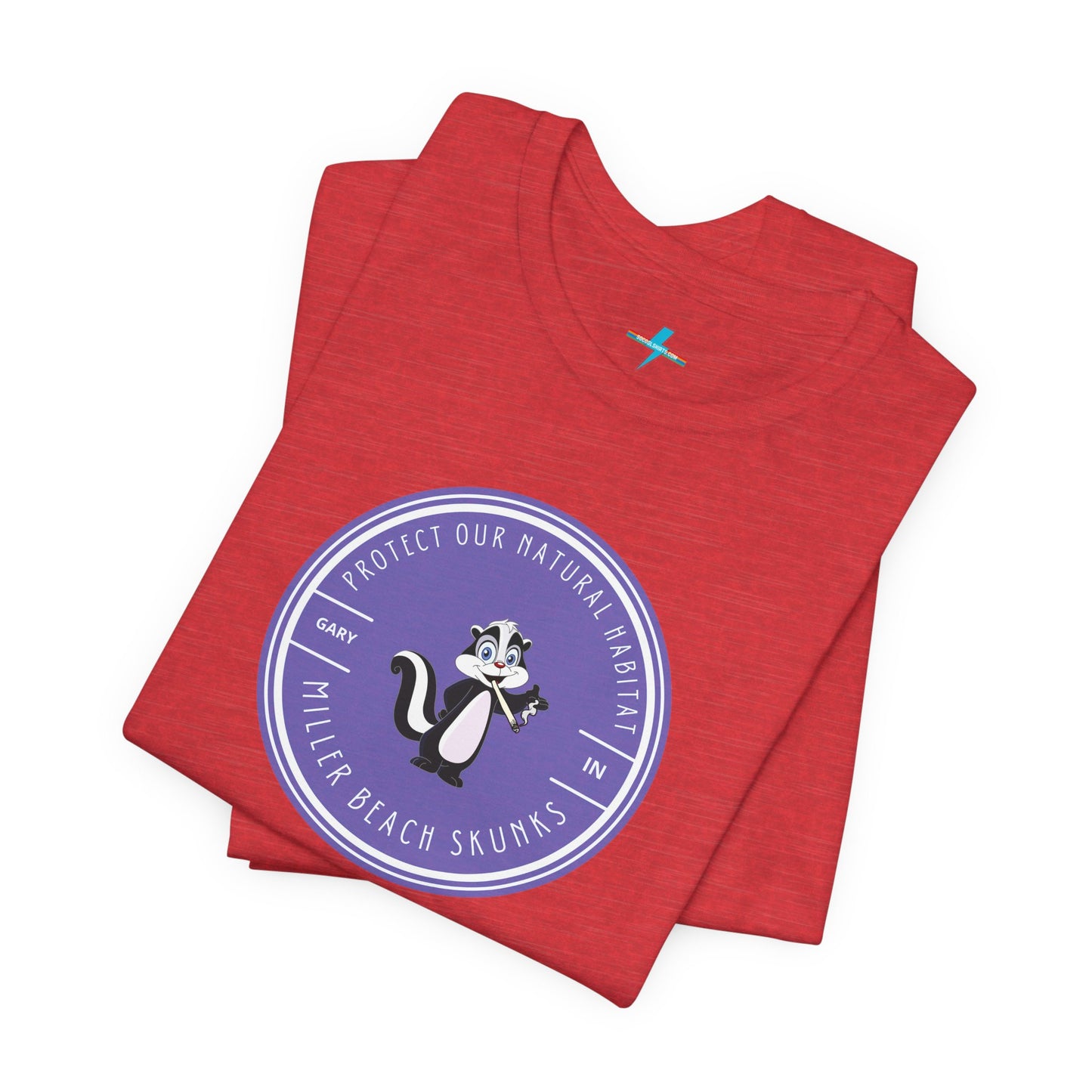 The Printify Miller Beach Skunks - Unisex Jersey Short Sleeve Tee is a gray T-shirt that features a circular blue logo at the center. Inside the logo, there is an illustration of a skunk with the text "Protect Our Habitat" and "Miller Beach Skunks" around the border, promoting environmental consciousness. The upper left part of the logo reads "Gary, IN.