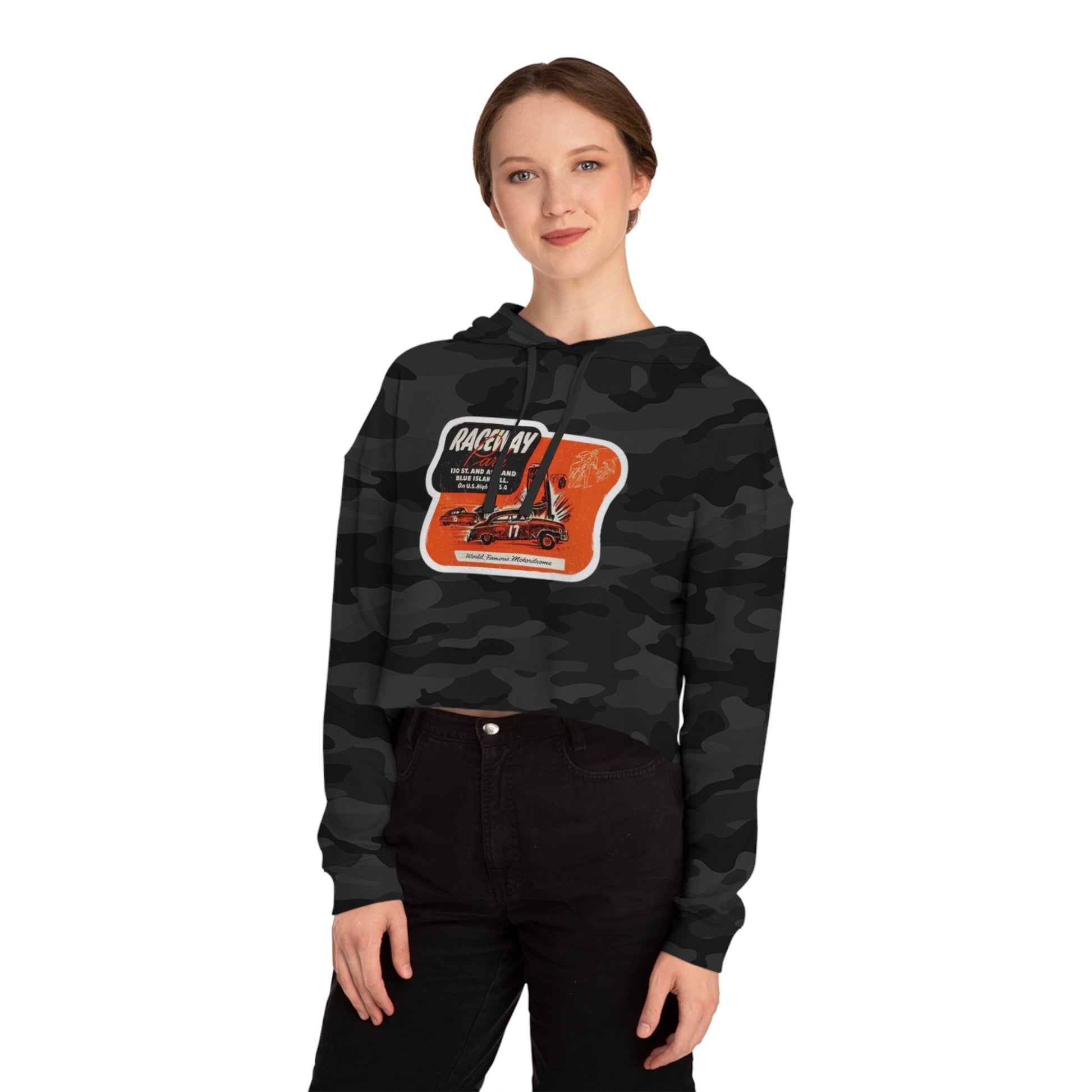 The Raceway Park - Blue Island, IL Women's Cropped Hooded Sweatshirt by Printify features an eye-catching camouflage pattern with a bold red and black "Raceway Park" graphic. Perfect for car enthusiasts, it is adorned with images of cars and text that celebrate a fictional race and hot rod theme, capturing the spirit of Blue Island racers.