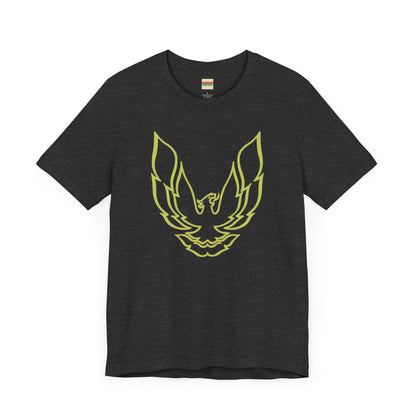 The Pontiac Trans Am Phoenix Shirt - Unisex Jersey Short Sleeve Tee by Printify is a classic black T-shirt that showcases a stylized yellow phoenix design on the front, reminiscent of the iconic Pontiac Trans Am. The shirt is displayed laid flat against a white background.