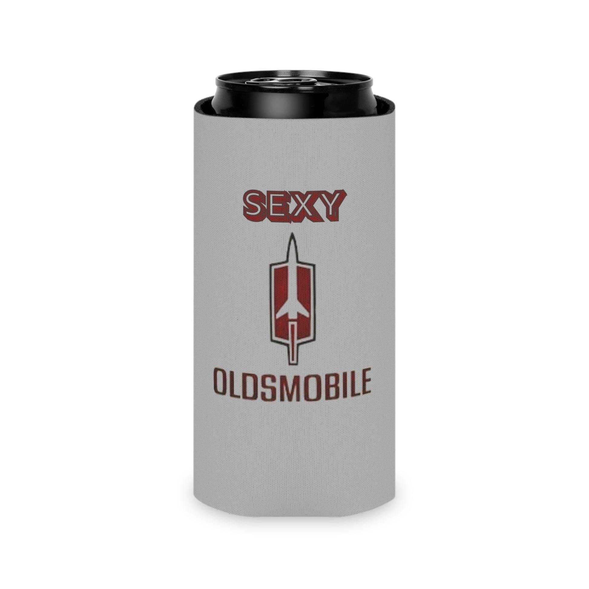 The Sexy Oldsmobile Koozie by Printify features "SEXY" in red at the top on a gray background, followed by the Oldsmobile logo and the word "OLDSMOBILE" below it. At the bottom, there's a blue and red logo reading "SOCOOLSHIRTS.COM." This koozie has an indentation designed to hold a can securely.