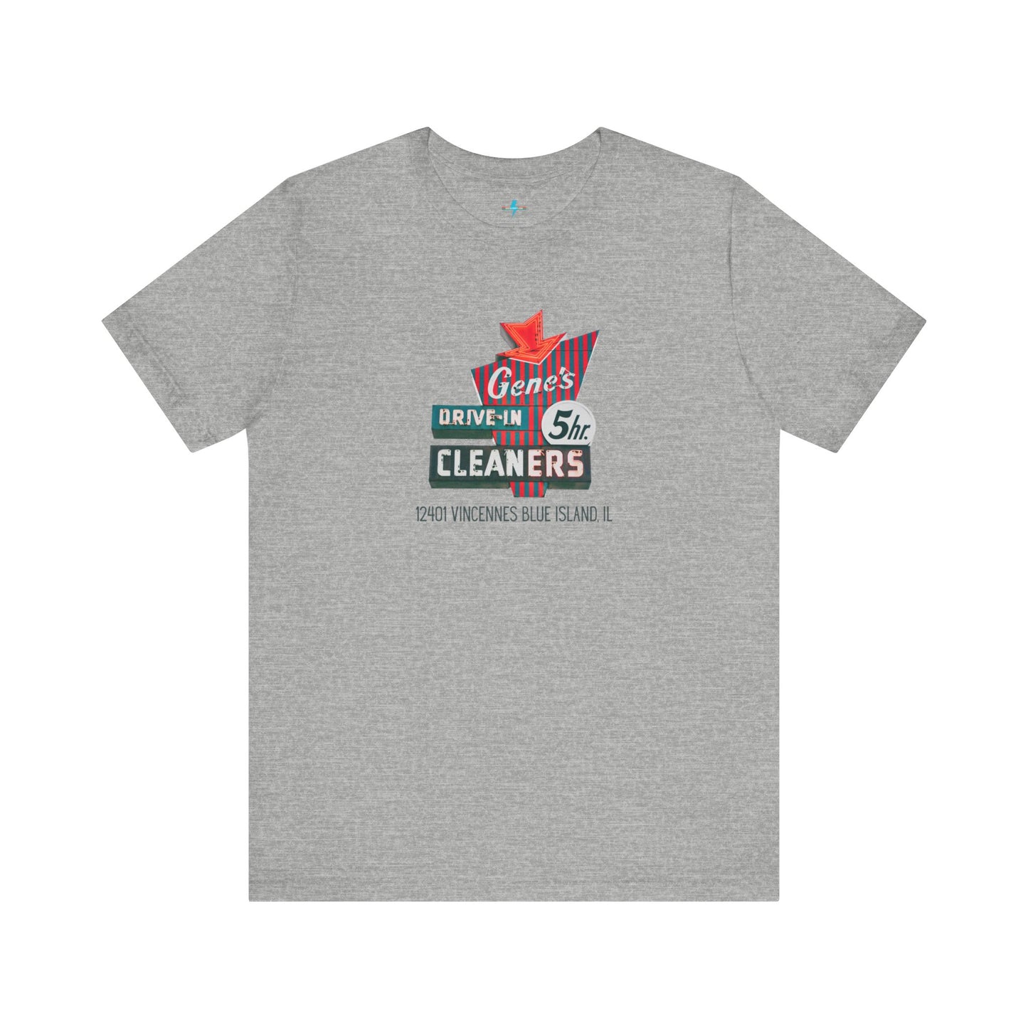 A unisex Jersey short sleeve tee from Printify featuring a light grey color with a retro-style graphic in the center. The design showcases text that reads "Gene's Drive In Cleaners, 5th," along with the address "12401 Vincennes Blue Island IL" in a blend of vintage fonts and colors, evoking the classic Chicago Fire-era vintage sign aesthetic.