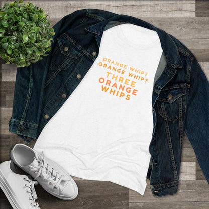 This Blues Brothers women's triblend tee from Printify features a dark gray vintage look with the text "ORANGE WHIP? ORANGE WHIP? THREE ORANGE WHIPS" printed in bright orange and yellow in the center. With a round neck and short sleeves, it's perfect for that retro vibe.