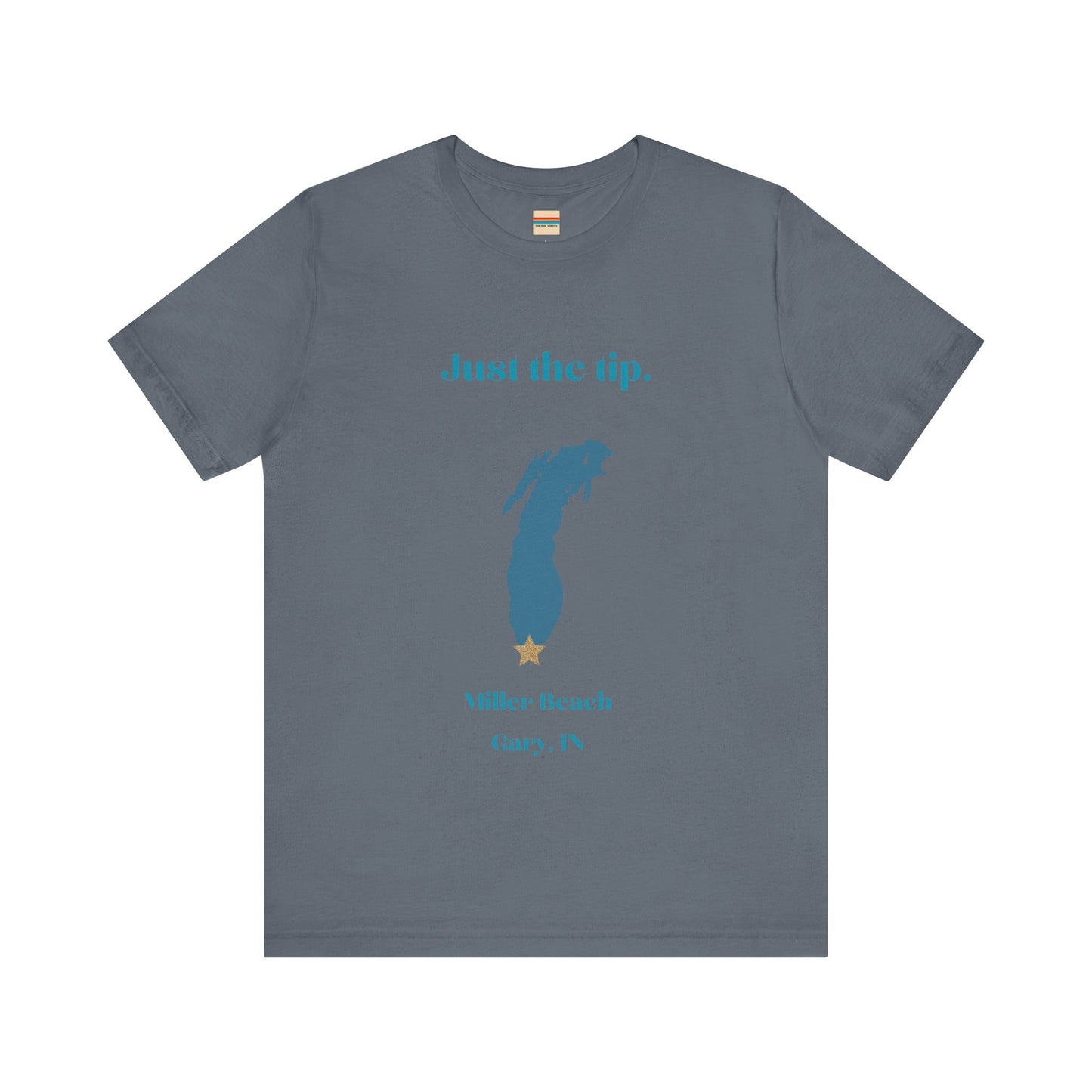 The Just the Tip - Miller Beach Unisex Jersey Short Sleeve Tee by Printify in yellow showcases text and a graphic design. The top displays "Just the tip" above a blue silhouette reminiscent of Indiana. At the bottom, it reads "Miller Beach" and "Gary, IN." Made from soft Airlume combed cotton, this tee offers both comfort and style.