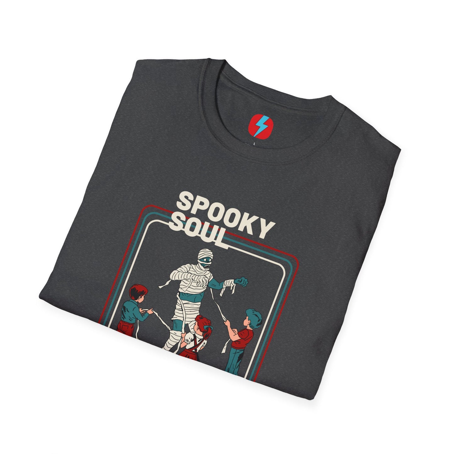 The Spooky Soul - Halloween - Unisex Softstyle T-Shirt by Printify, available in dark gray, showcases a retro-style graphic of a mummy dancing with two kids in Halloween costumes. The text "SPOOKY SOUL" is displayed above the image, which is framed by red and blue lines to enhance its vintage feel.