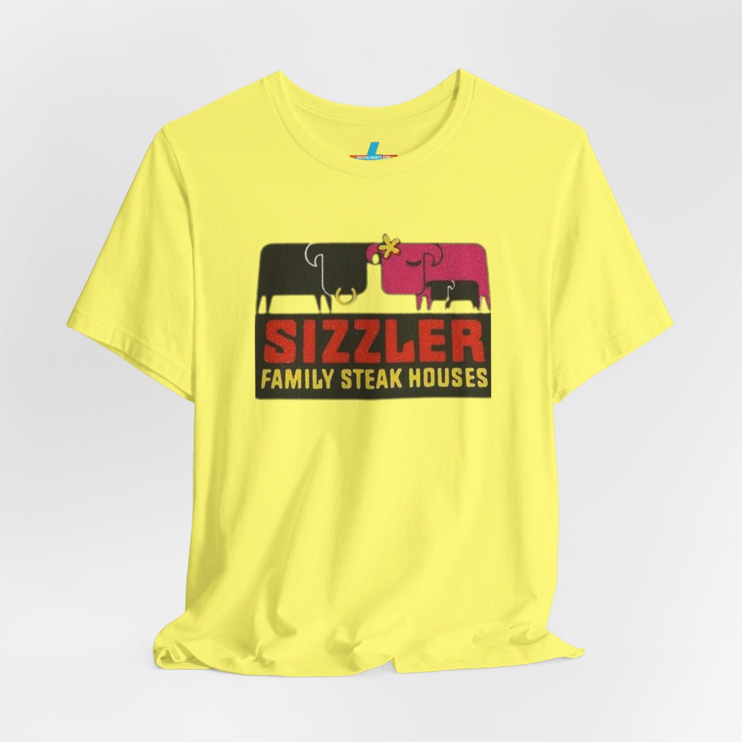 The "Sizzler Family Steakhouses - Retro 1981 Logo - Unisex Jersey Short Sleeve Tee" by Printify is a gray t-shirt showcasing a retro-style graphic with two black and pink cows, a cactus, and the text "Sizzler Family Steak Houses" in vibrant red and yellow. Ideal for any retro enthusiast, this design evokes nostalgia reminiscent of vintage restaurant logos from 1981.