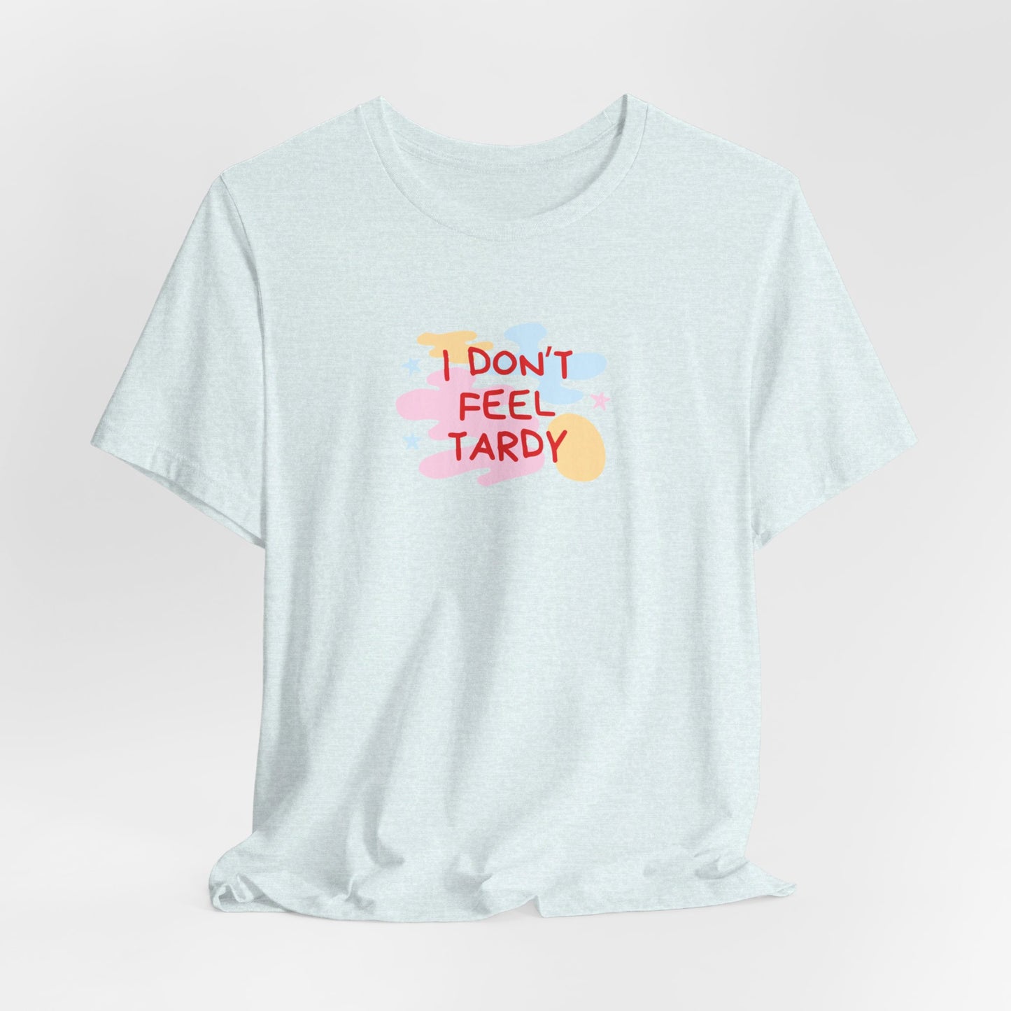 The "I Don't Feel Tardy - 1980s Retro - Unisex Jersey Short Sleeve Tee" from Printify is a light pink jersey shirt that features the bold, colorful text "I DON'T FEEL TARDY" prominently at its center. This design exudes retro vibes with small star shapes and abstract splashes of blue, yellow, and pink, laid flat against a plain background to channel pure Van Halen T-shirt energy.