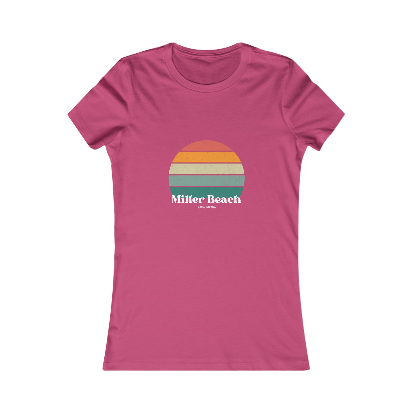 The Printify Women's Favorite Tee - Miller Beach Gary, IN Retro Sunset is a pink women's T-shirt showcasing a retro-style graphic of a sun with horizontal stripes in orange, yellow, and green. Designed with a feminine fit, the airlume combed cotton fabric offers premium softness. Below the sun, the text reads "Miller Beach" in white, with smaller text underneath that is not legible.