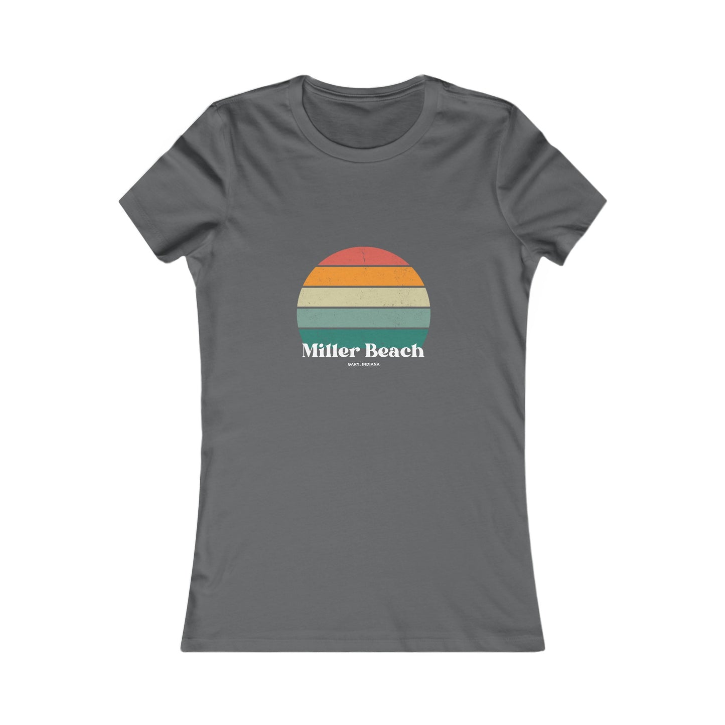 The Printify Women's Favorite Tee - Miller Beach Gary, IN Retro Sunset is a pink women's T-shirt showcasing a retro-style graphic of a sun with horizontal stripes in orange, yellow, and green. Designed with a feminine fit, the airlume combed cotton fabric offers premium softness. Below the sun, the text reads "Miller Beach" in white, with smaller text underneath that is not legible.