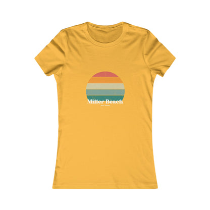 The Printify Women's Favorite Tee - Miller Beach Gary, IN Retro Sunset is a pink women's T-shirt showcasing a retro-style graphic of a sun with horizontal stripes in orange, yellow, and green. Designed with a feminine fit, the airlume combed cotton fabric offers premium softness. Below the sun, the text reads "Miller Beach" in white, with smaller text underneath that is not legible.