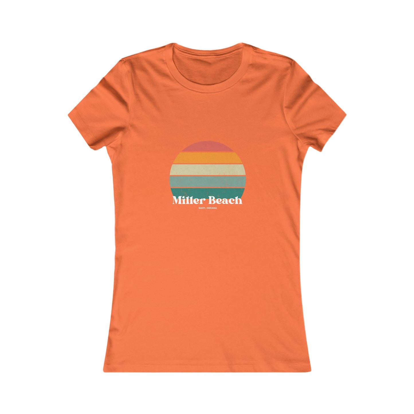 The Printify Women's Favorite Tee - Miller Beach Gary, IN Retro Sunset is a pink women's T-shirt showcasing a retro-style graphic of a sun with horizontal stripes in orange, yellow, and green. Designed with a feminine fit, the airlume combed cotton fabric offers premium softness. Below the sun, the text reads "Miller Beach" in white, with smaller text underneath that is not legible.