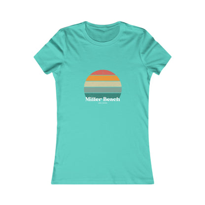 The Printify Women's Favorite Tee - Miller Beach Gary, IN Retro Sunset is a pink women's T-shirt showcasing a retro-style graphic of a sun with horizontal stripes in orange, yellow, and green. Designed with a feminine fit, the airlume combed cotton fabric offers premium softness. Below the sun, the text reads "Miller Beach" in white, with smaller text underneath that is not legible.