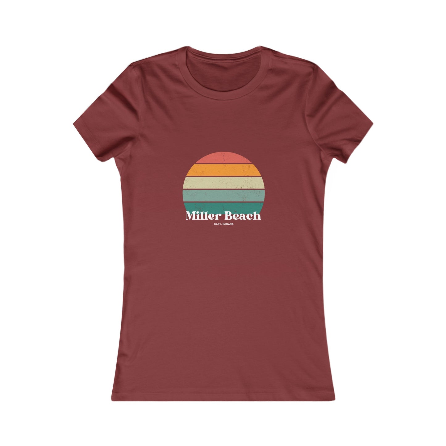 The Printify Women's Favorite Tee - Miller Beach Gary, IN Retro Sunset is a pink women's T-shirt showcasing a retro-style graphic of a sun with horizontal stripes in orange, yellow, and green. Designed with a feminine fit, the airlume combed cotton fabric offers premium softness. Below the sun, the text reads "Miller Beach" in white, with smaller text underneath that is not legible.