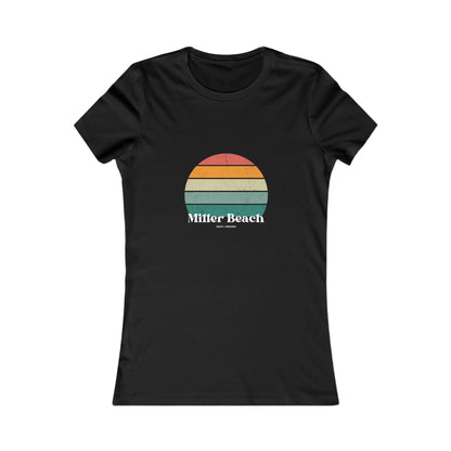 The Printify Women's Favorite Tee - Miller Beach Gary, IN Retro Sunset is a pink women's T-shirt showcasing a retro-style graphic of a sun with horizontal stripes in orange, yellow, and green. Designed with a feminine fit, the airlume combed cotton fabric offers premium softness. Below the sun, the text reads "Miller Beach" in white, with smaller text underneath that is not legible.