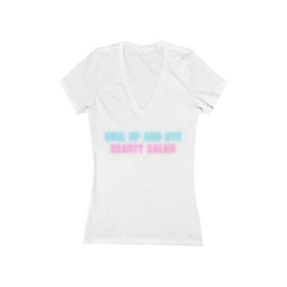 A Printify Blues Brothers Curl Up and Dye Women's Jersey Short Sleeve Deep V-Neck Tee in light gray is shown against a white background. This comfortable wardrobe essential showcases "CURL UP AND DYE" in light blue and "BEAUTY SALON" in light pink printed across the chest, featuring a modern feminine fit.