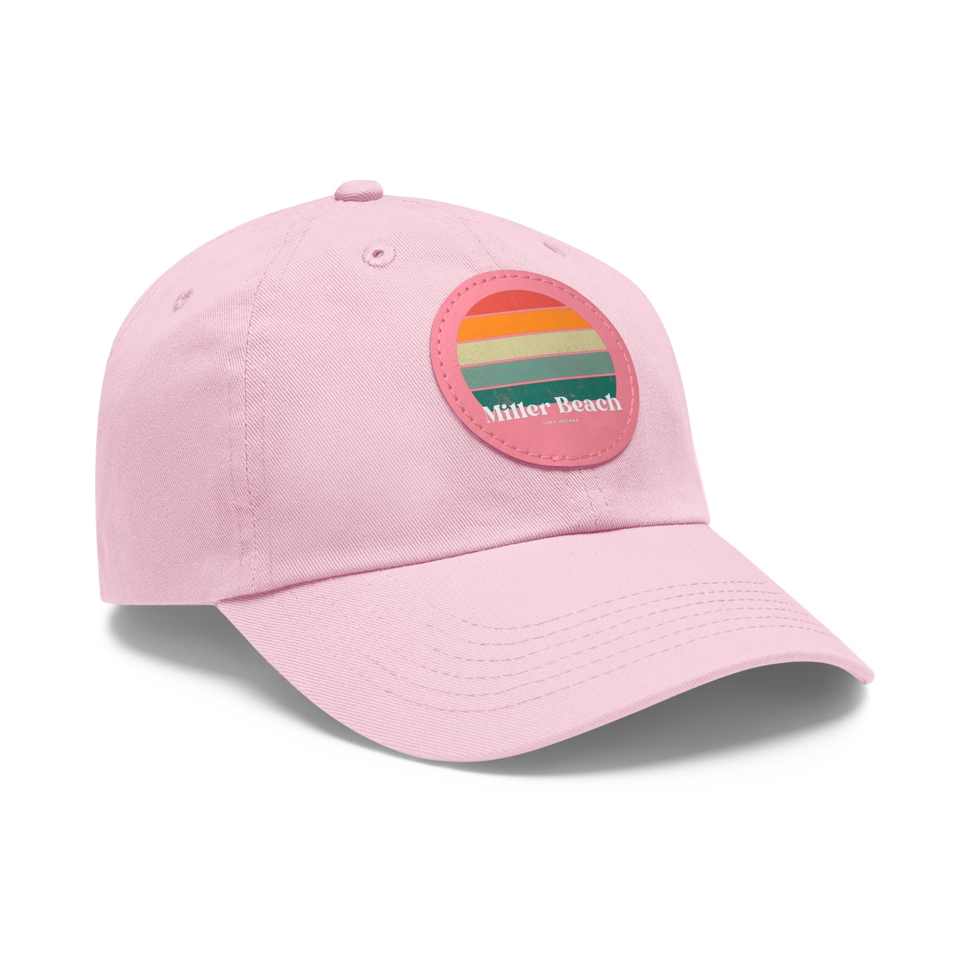 The Miller Beach Retro Sunset - Dad Hat with Leather Patch (Round) by Printify is a pink baseball cap crafted from bio-washed chino twill for added comfort. It features a PU leather patch adorned with horizontal stripes in red, orange, yellow, green, and blue. Below the stripes, "Miller Beach" is embroidered in white. An adjustable strap at the back ensures a perfect fit.