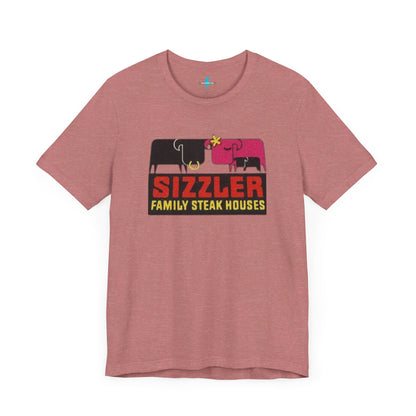 The "Sizzler Family Steakhouses - Retro 1981 Logo - Unisex Jersey Short Sleeve Tee" by Printify is a gray t-shirt showcasing a retro-style graphic with two black and pink cows, a cactus, and the text "Sizzler Family Steak Houses" in vibrant red and yellow. Ideal for any retro enthusiast, this design evokes nostalgia reminiscent of vintage restaurant logos from 1981.