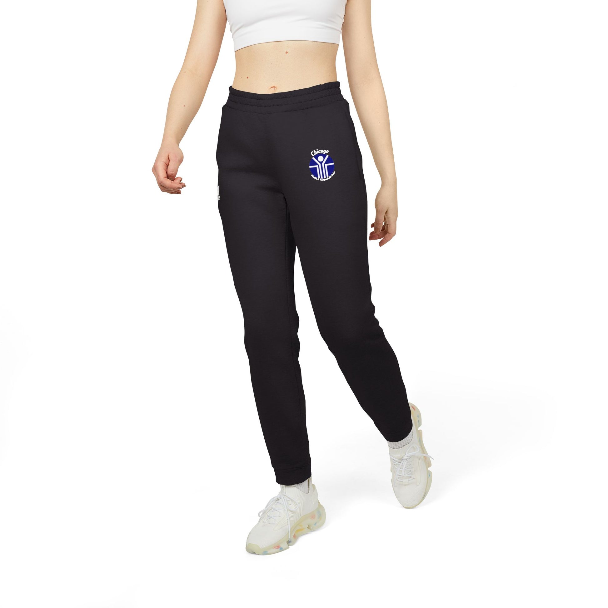 Gray Adidas unisex fleece joggers from Printify, showcasing the classic Chicago Health Clubs - Bally's 1980s logo on the left thigh and a blue and white emblem on the right. Crafted from sustainable BCI cotton, these joggers feature an elastic waistband and cuffs for maximum comfort.