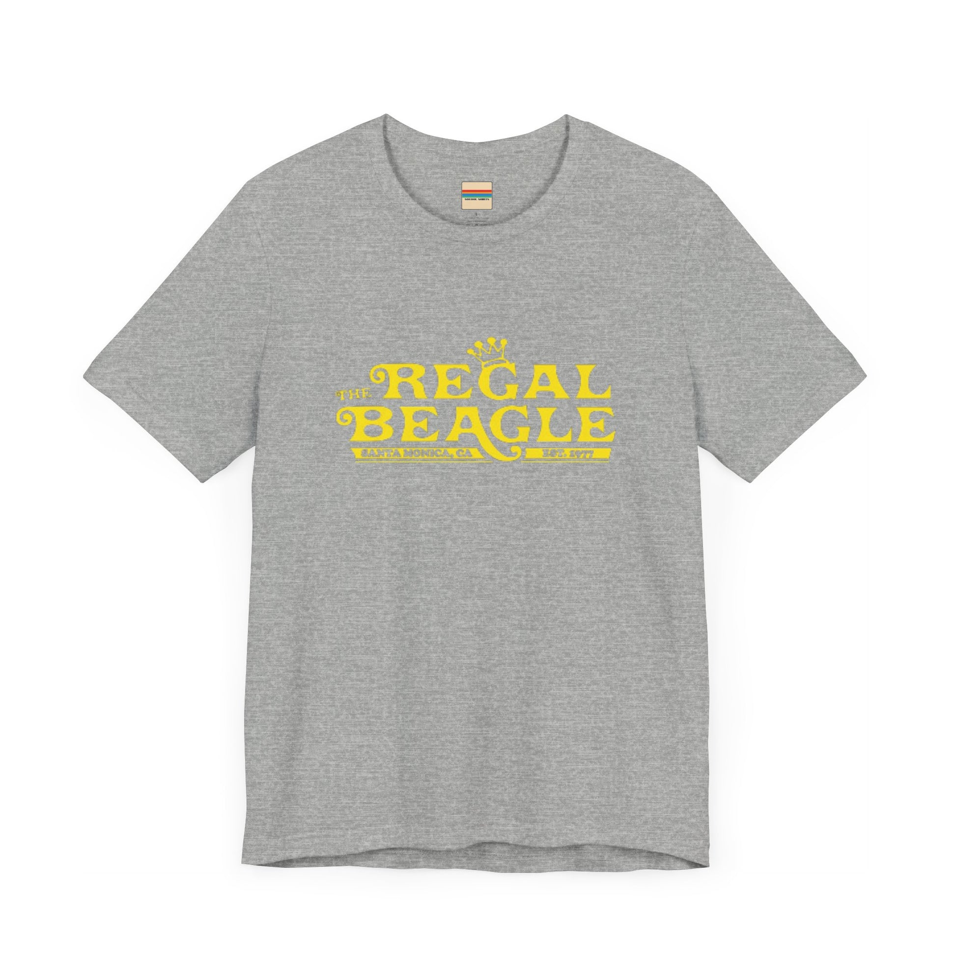 The Printify Regal Beagle - Three's Company Unisex Jersey Short Sleeve Tee, in black, showcases "The Regal Beagle, Santa Monica, CA, Est. 1977" text in a yellow vintage-style font. Crafted from 100% Airlume combed cotton for superior comfort.