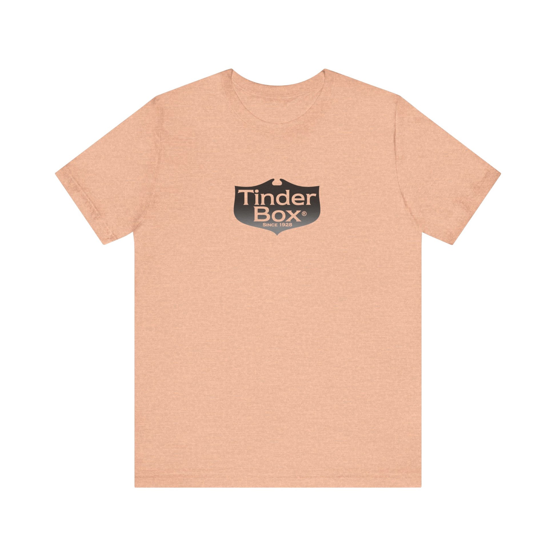 A light blue Printify "The Tinder Box 1980s" unisex jersey short sleeve tee featuring the "Tinder Box" logo in the center. The logo consists of a dark shield with the words "Tinder Box" in white text, with a small flame icon replacing the dot above the "i".