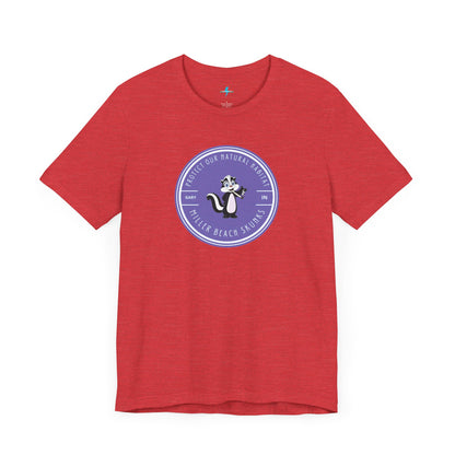 The Printify Miller Beach Skunks - Unisex Jersey Short Sleeve Tee is a gray T-shirt that features a circular blue logo at the center. Inside the logo, there is an illustration of a skunk with the text "Protect Our Habitat" and "Miller Beach Skunks" around the border, promoting environmental consciousness. The upper left part of the logo reads "Gary, IN.