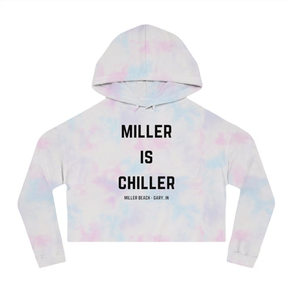 A white Women's Cropped Hooded Sweatshirt by Printify, featuring the phrase "MILLER IS CHILLER" printed in bold black letters on the front. Below the phrase, it says "MILLER BEACH • GARY, IN" in smaller black text. The SoCool Shirts hoodie includes a drawstring hood and long sleeves.