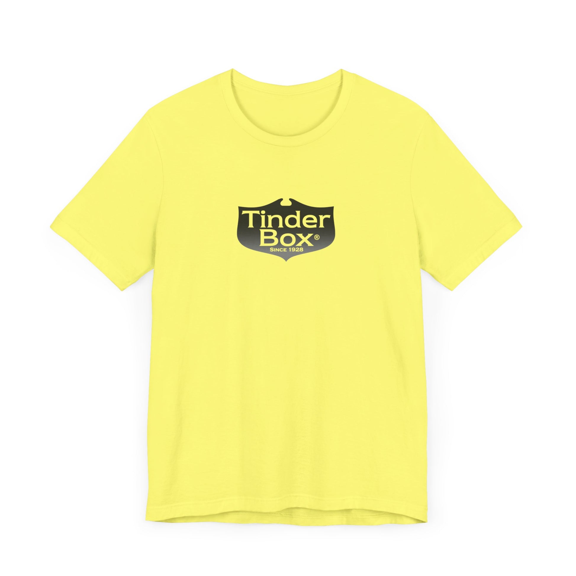 A light blue Printify "The Tinder Box 1980s" unisex jersey short sleeve tee featuring the "Tinder Box" logo in the center. The logo consists of a dark shield with the words "Tinder Box" in white text, with a small flame icon replacing the dot above the "i".