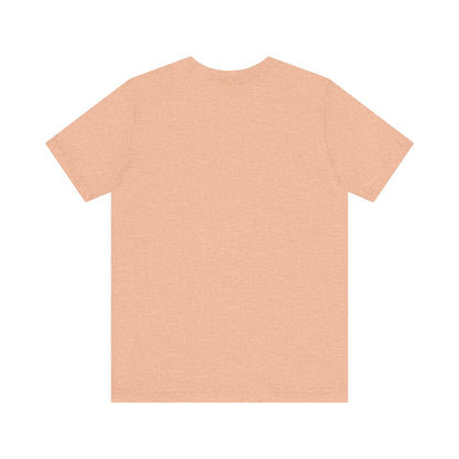 A light blue Printify "The Tinder Box 1980s" unisex jersey short sleeve tee featuring the "Tinder Box" logo in the center. The logo consists of a dark shield with the words "Tinder Box" in white text, with a small flame icon replacing the dot above the "i".