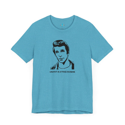 A white unisex jersey short sleeve tee by Printify, named "Caught in a Fonzi Scheme - Happy Days - Retro," features a black and white illustration of a person with a serious expression and styled hair, perfectly capturing the nostalgic apparel vibe. Below the illustration, the text reads "CAUGHT IN A FONZI SCHEME," making it an ideal Happy Days tribute shirt.