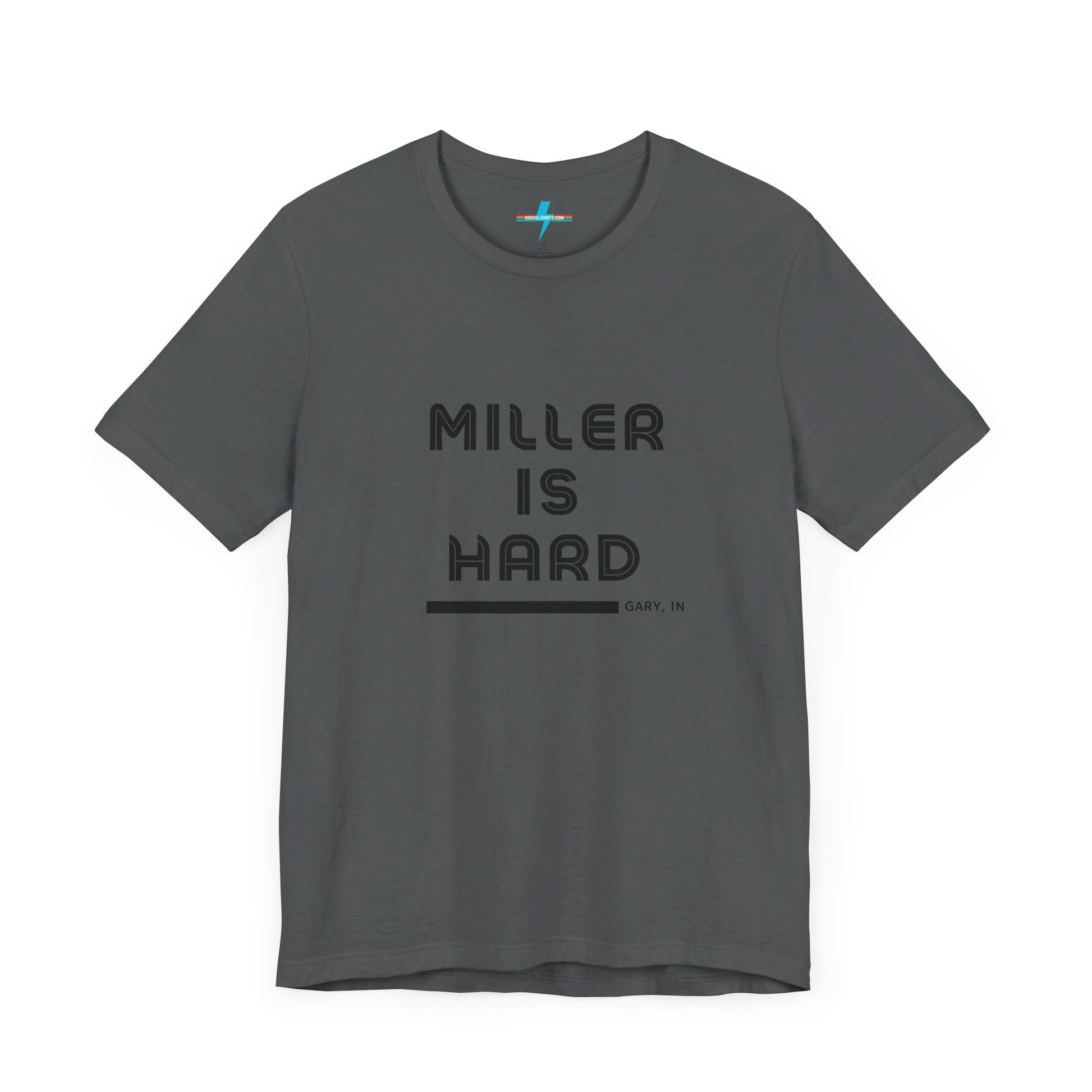 A unisex jersey short sleeve tee from Printify in burnt orange features the bold black text "MILLER IS HARD" on the chest, with "GARY, IN" written beneath in smaller black font. Perfect for showcasing Miller Beach's iconic spirit, this t-shirt is displayed against a plain white background.