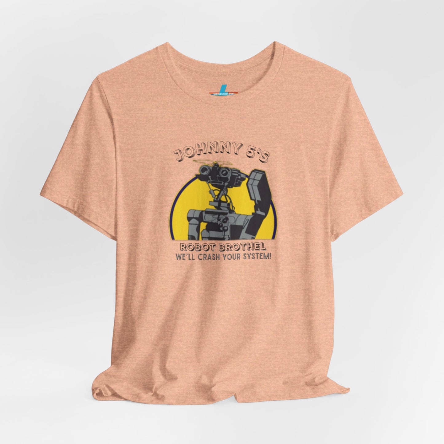 A vibrant orange unisex jersey short sleeve tee from Printify showcases a graphic of a small robot detailed in black and grey. Above the robot, retro robotics text reads "Johnny 5’s Robot Br*thel," while below, it says "We'll Crash Your System!" in a smaller font.