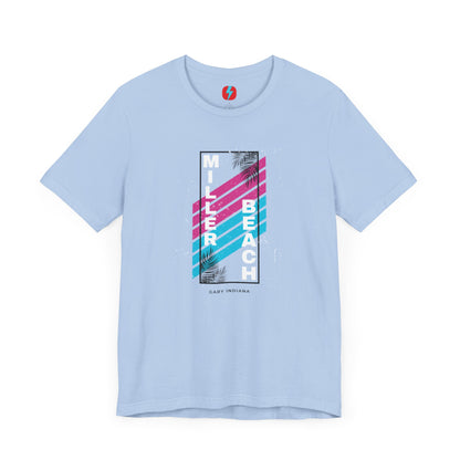 The Printify Miller Beach 1980s Style Unisex Jersey Short Sleeve Tee features a light blue base with retro-inspired diagonal stripes in blue and pink. "Miller Beach" is vertically displayed in white alongside black palm leaves, with "Gary Indiana" written at the bottom.